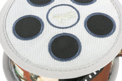 Close-up of a white object with black circular patterns on a colorful background